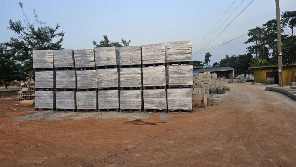 Pallets of finished concrete blocks stacked across the Quasi yard