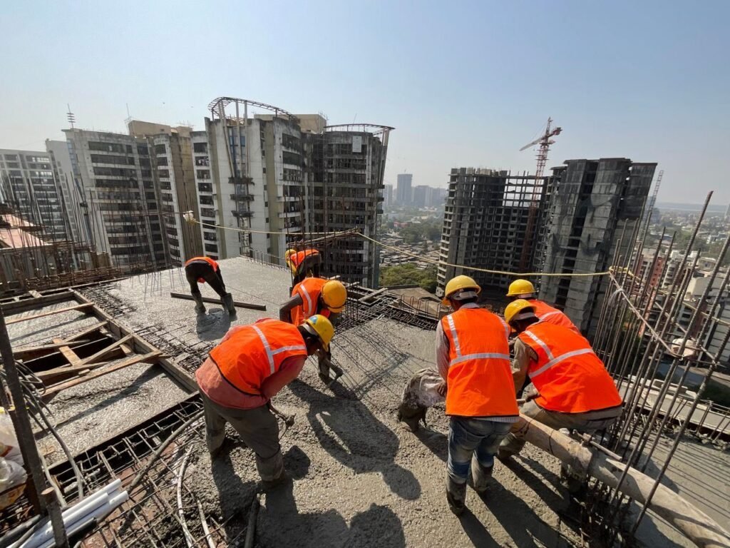 Construction crew placing concrete on a high-rise slab